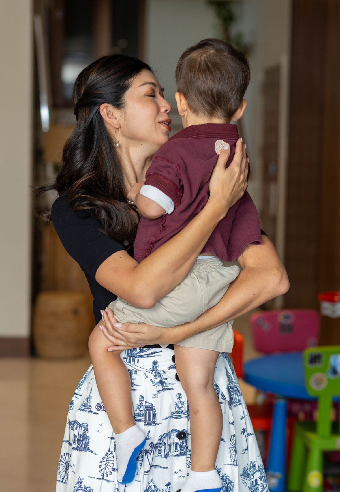 Dr. Stacy Chiang in a tender moment with her son at home in Singapore